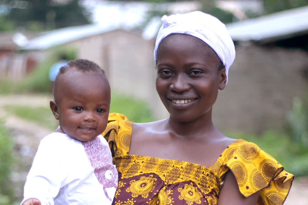 Mokpokpo holds her baby Ayikoe