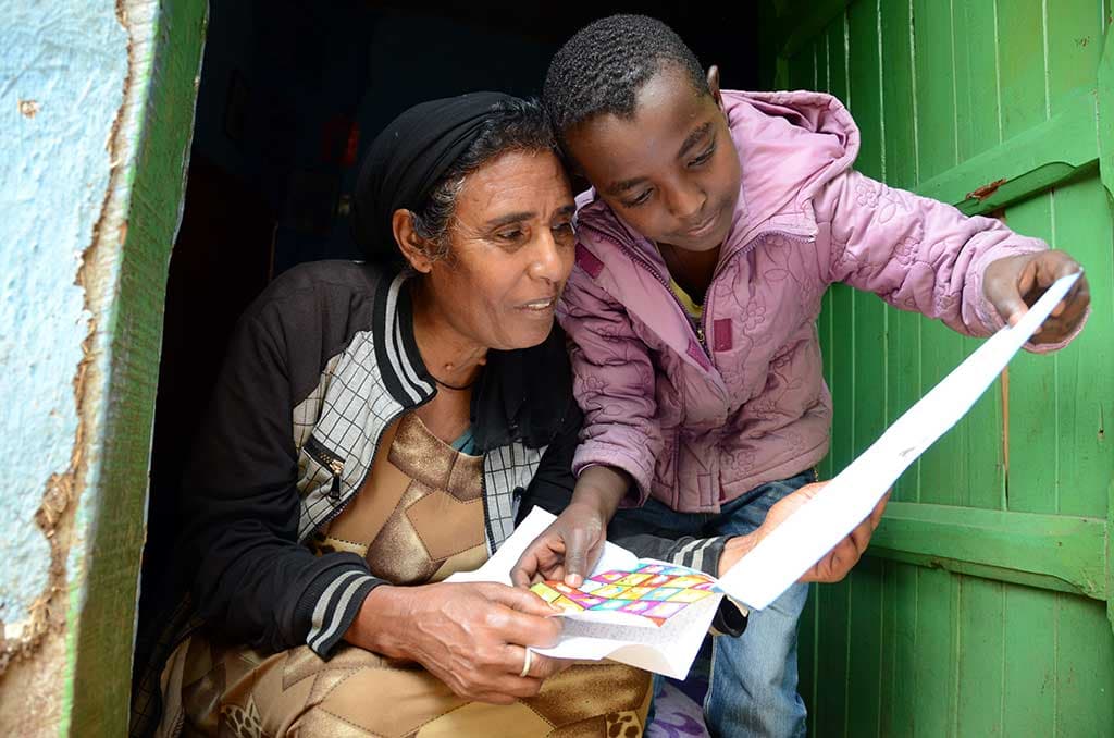 Nathnael from Ethiopia reading sponsor letters