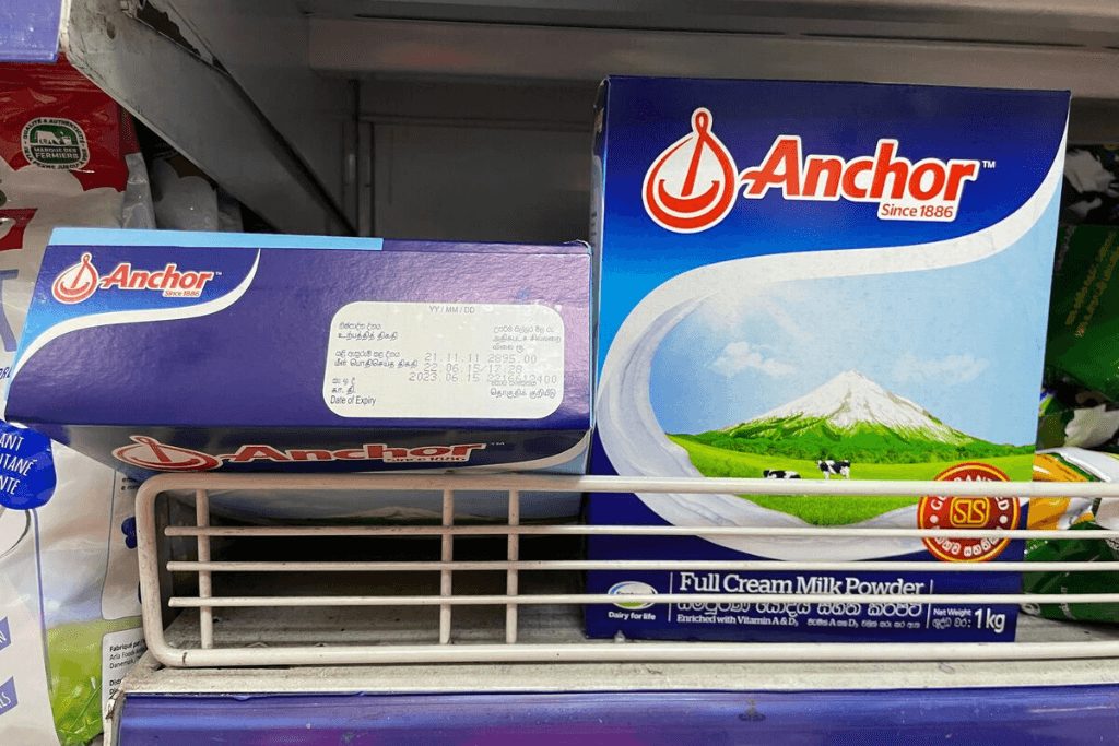 Powdered milk sits on a supermarket shelf.