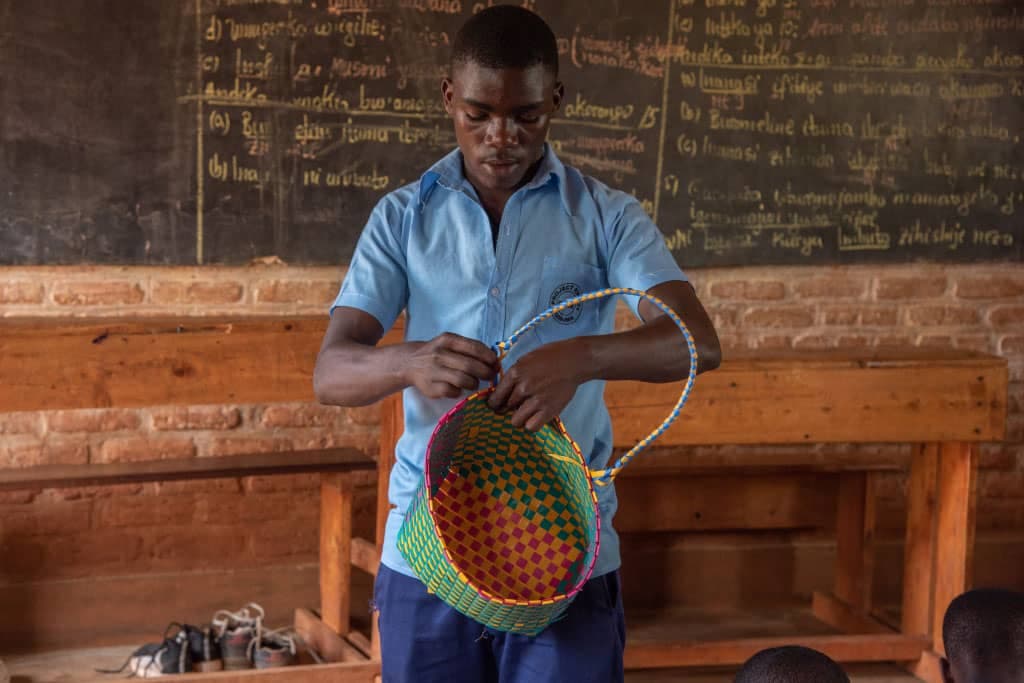 Sebastian weaves a basket