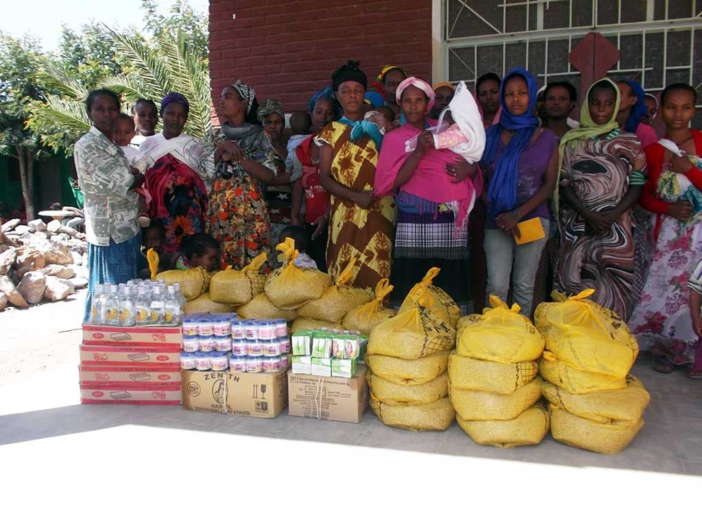 Compassion mothers with food packages in Ethiopia