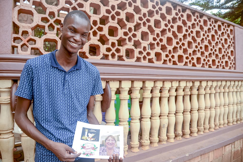 young man holding letter