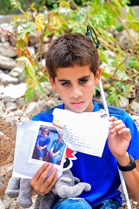 blind boy with his sponsor's letters