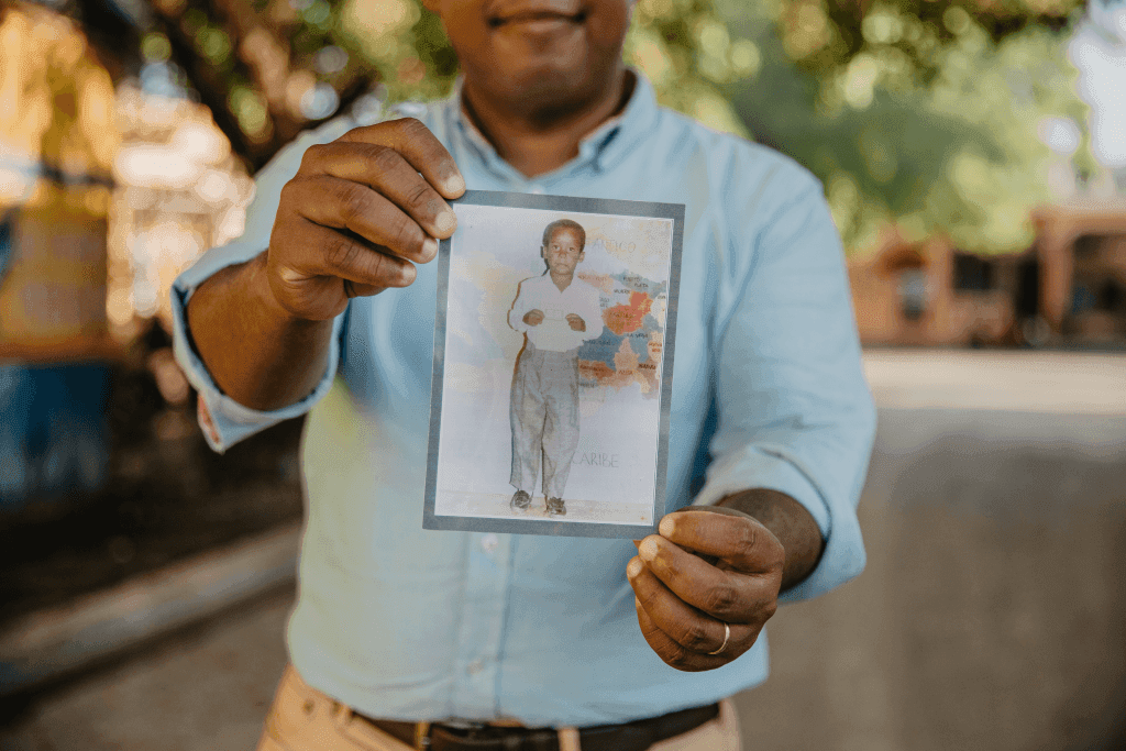 Tony Beltran, DR National Director with photo of himself as a child