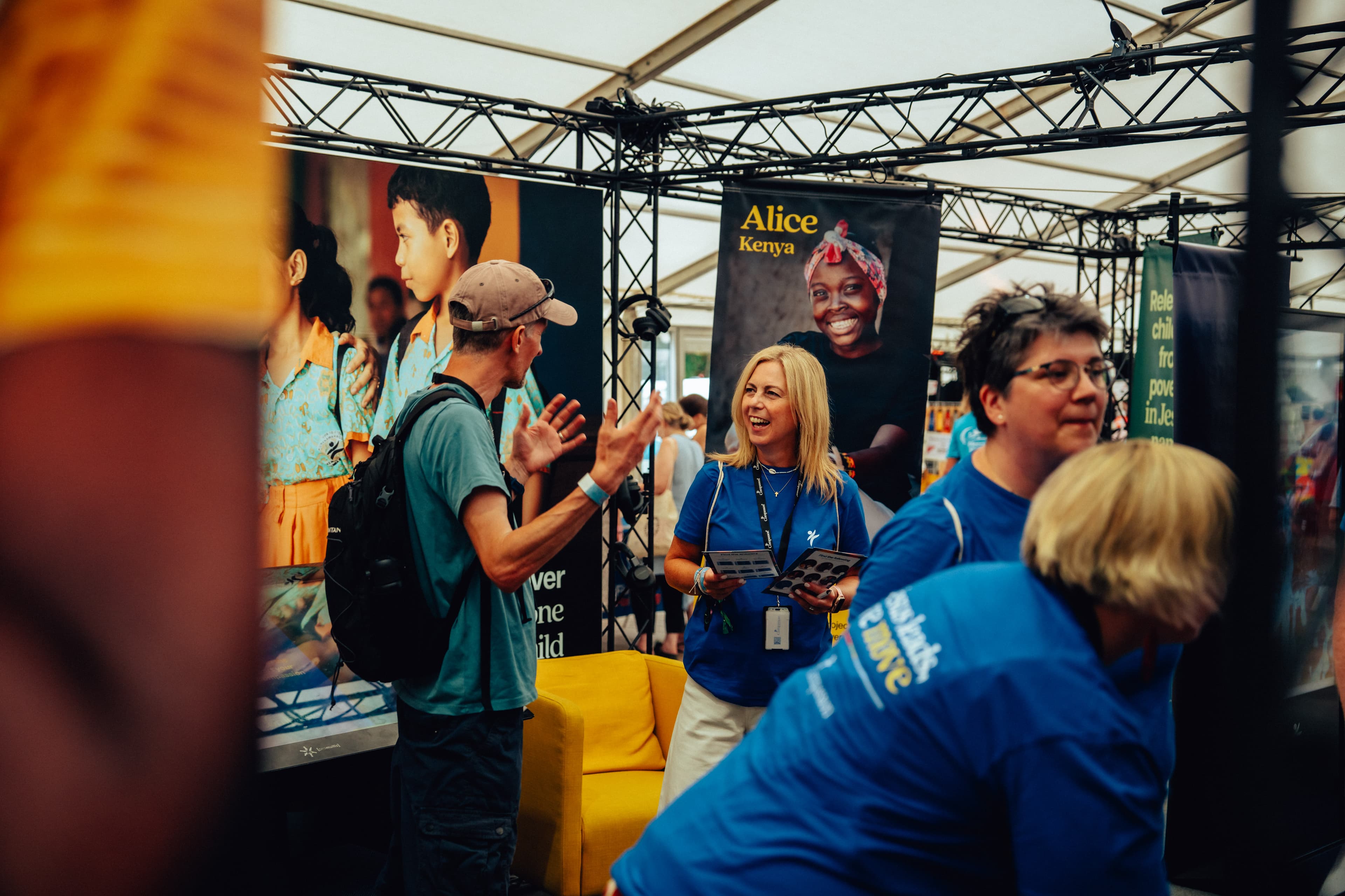 Woman advocating for Compassion talking to a man at the Compassion stall.