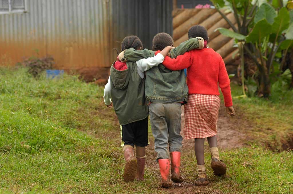 Friends walking arm in arm
