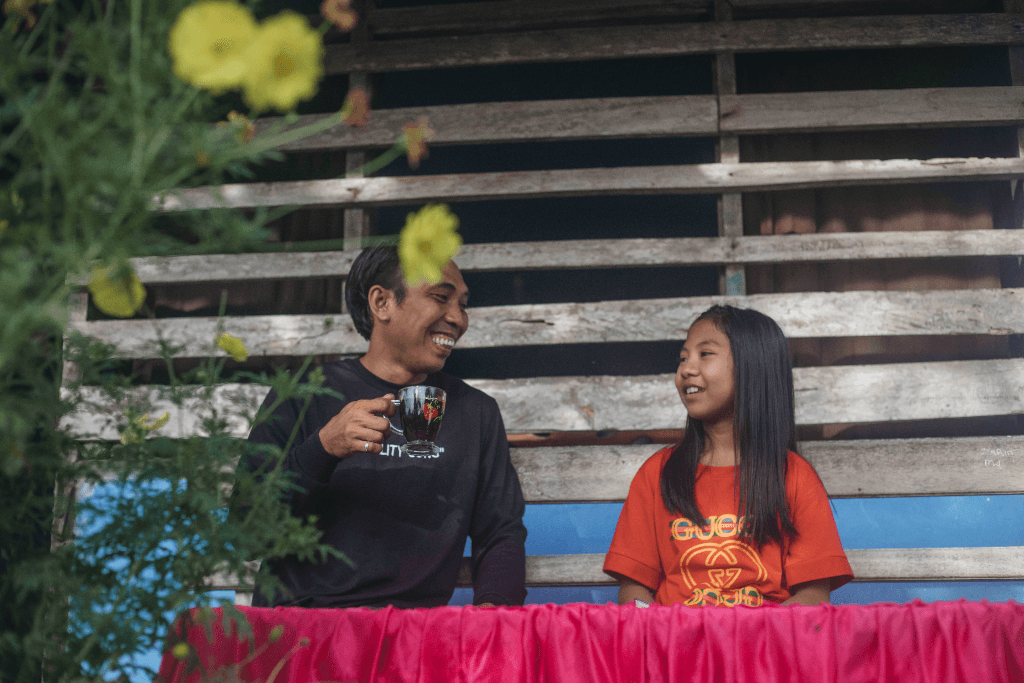 Tivani is spending time with her father outside their home.