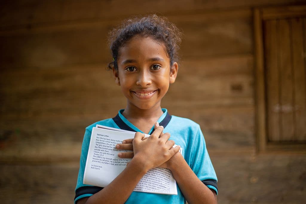 A girl holding a letter