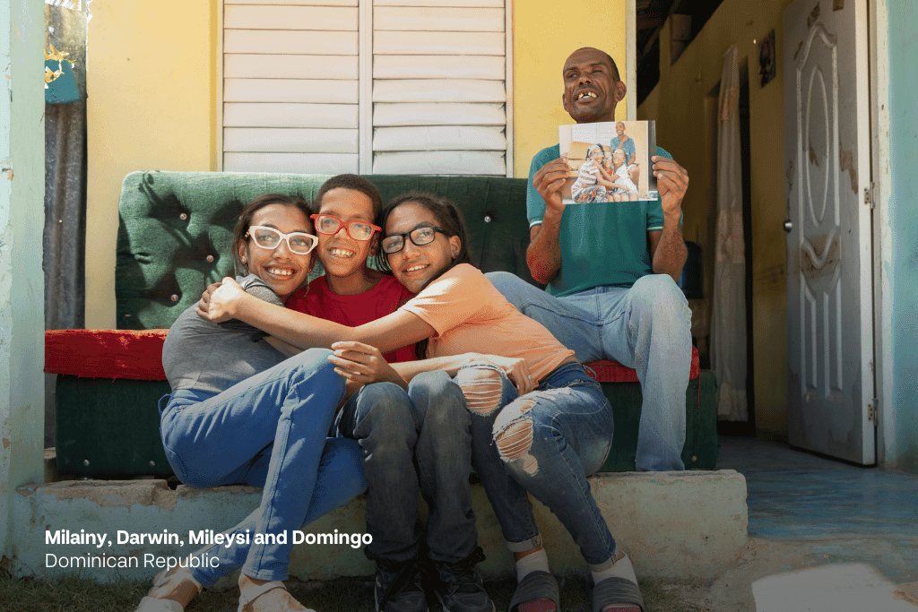 Milainy, Darwin, Mileysi and Domingo sit outside their home