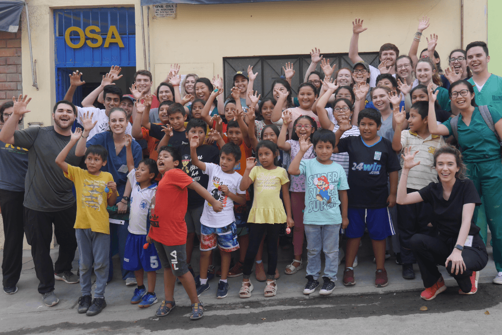 A group of children and adults waving