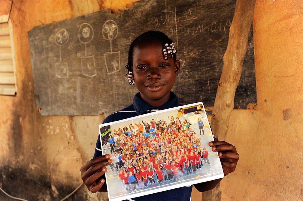 Sponsored girl in Burkina Faso holding photo