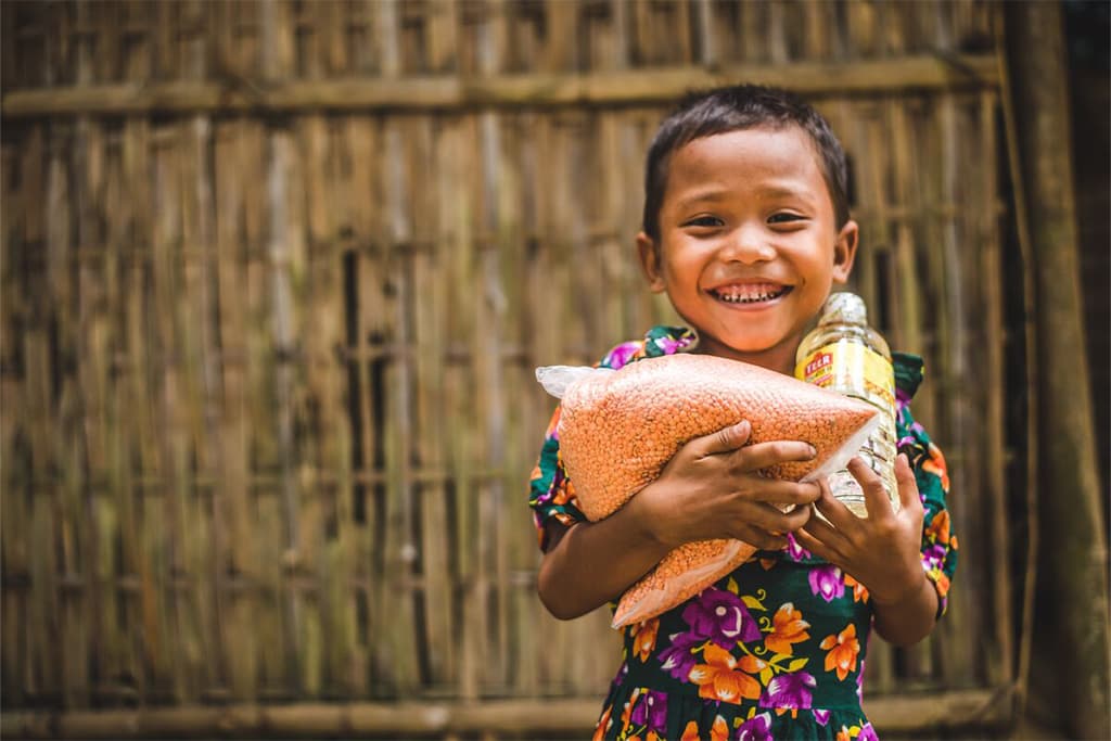 A boy holding a food parcel