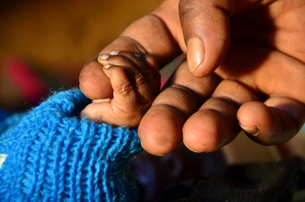 Holding baby hand