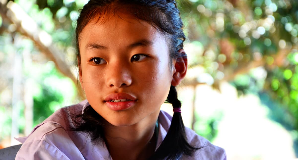 A girl in Thailand looks into the distance