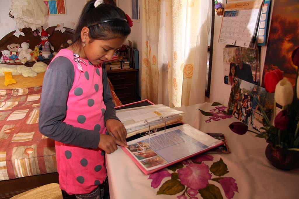 Nuria reading letters from her sponsor