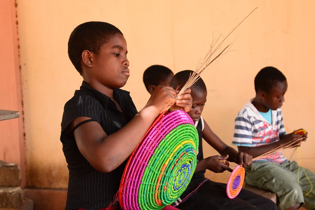 Children in Togo making baskets