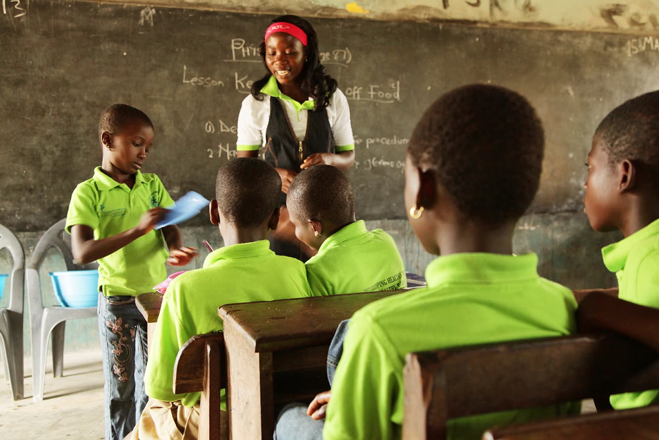 ghana teacher in classroom with pupils