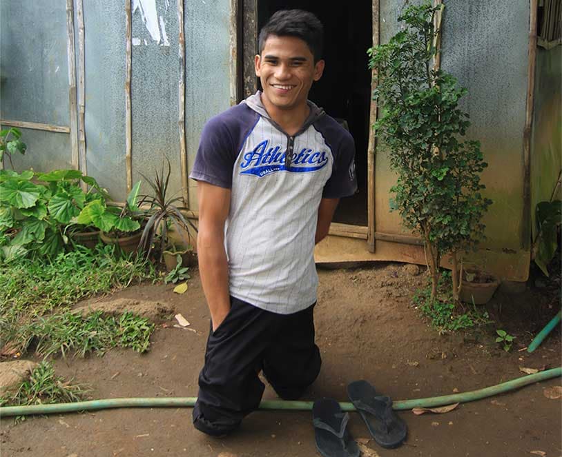 Denard outside his home