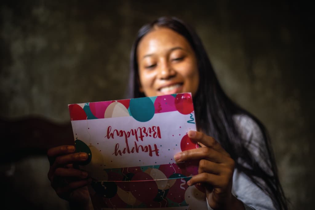 girl reading birthday card