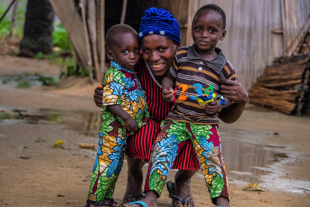 Ama hugs her two sons