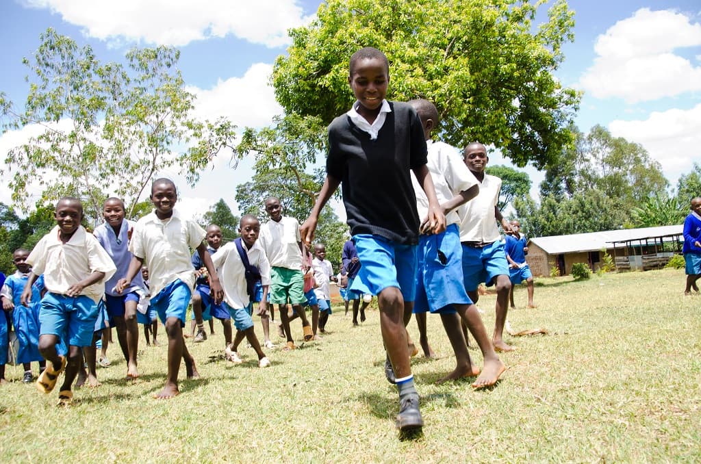 A group of boys playing outside of their Compassion project