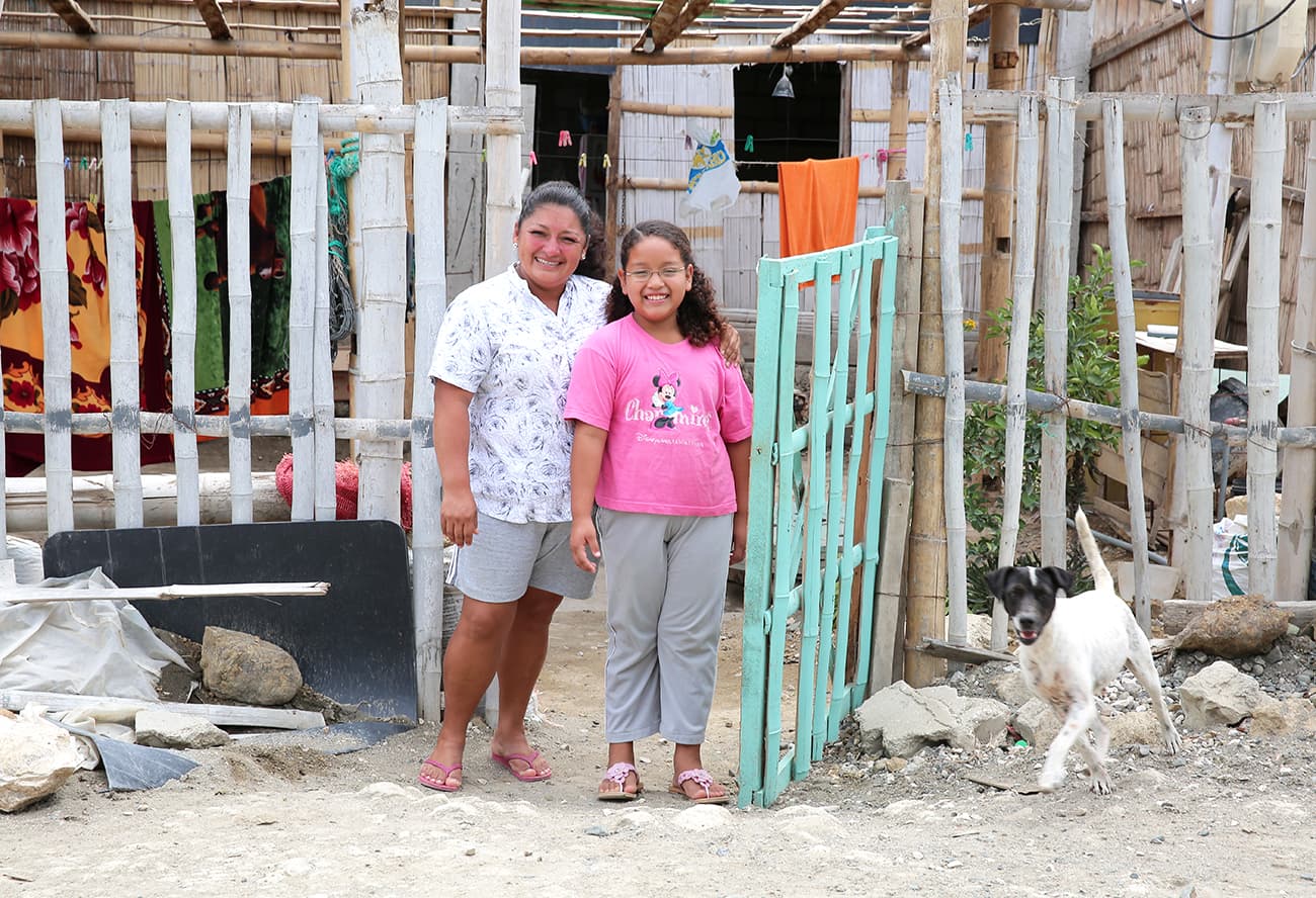 Karlita and her mum standing outside their house