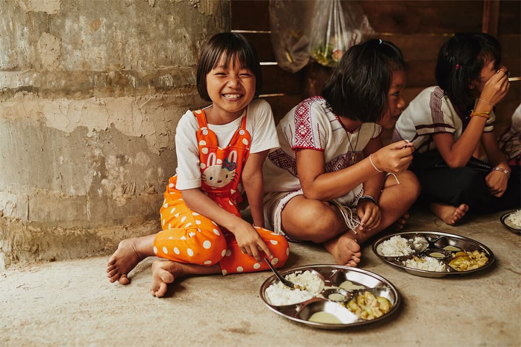 A group of girls sharing a meal in Thailand