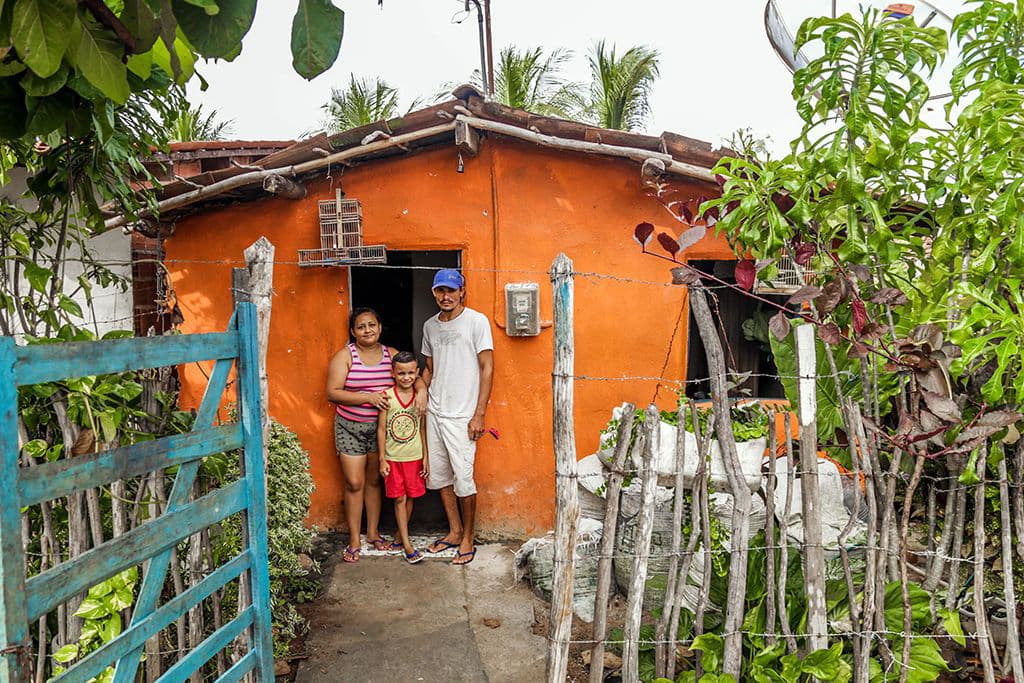 Antonio, Rosilene and Francisco outside their home