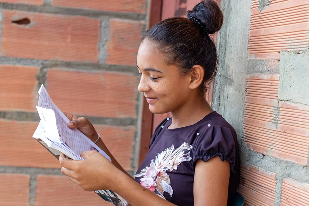 Dayana reading letter from her sponsor