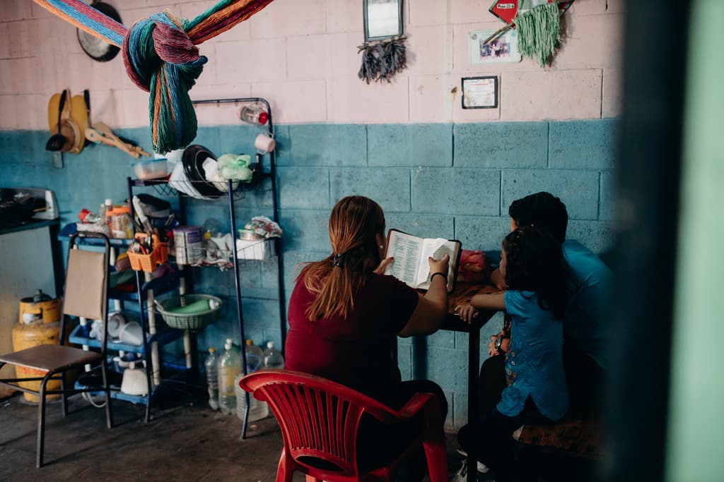 Luisa and family reading the Bible together at their home
