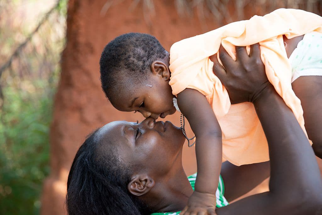 Mum kissing daughter in Togo
