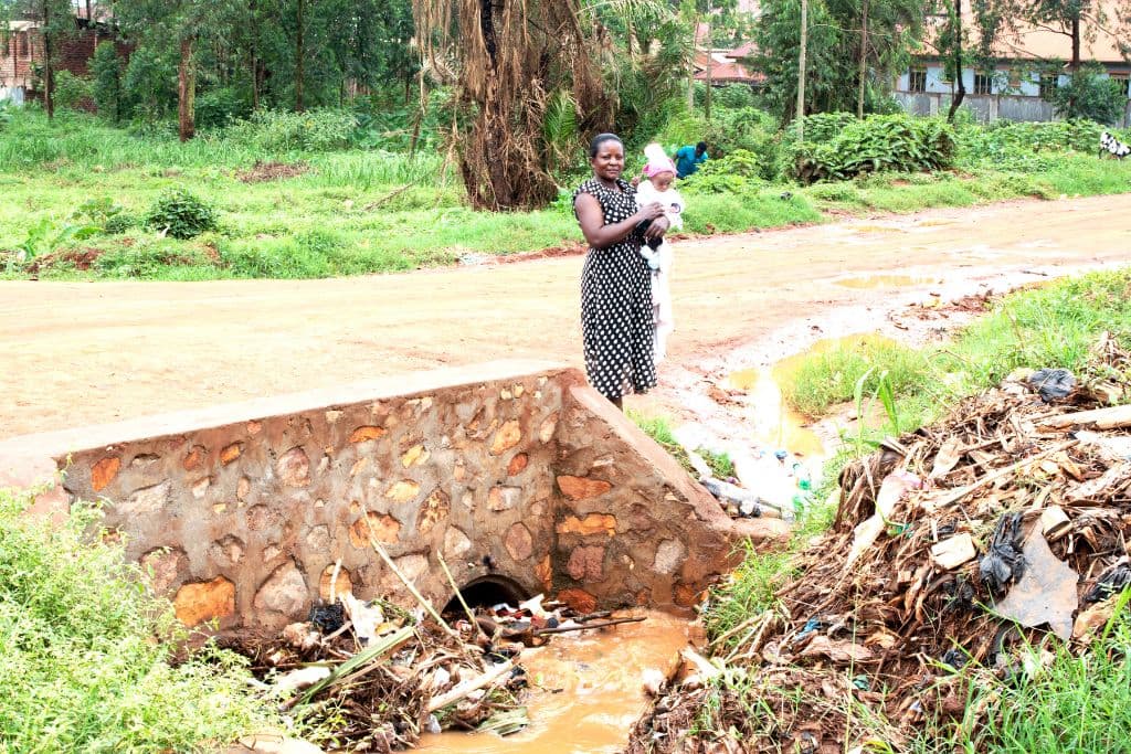 Glady and Miracle standing by the drain, February 2023.