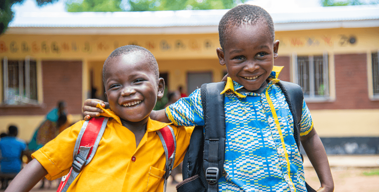 Two particpants smiling at their project in Malawi f