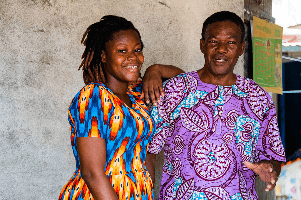 Winner stands with her arm on her father's shoulder.