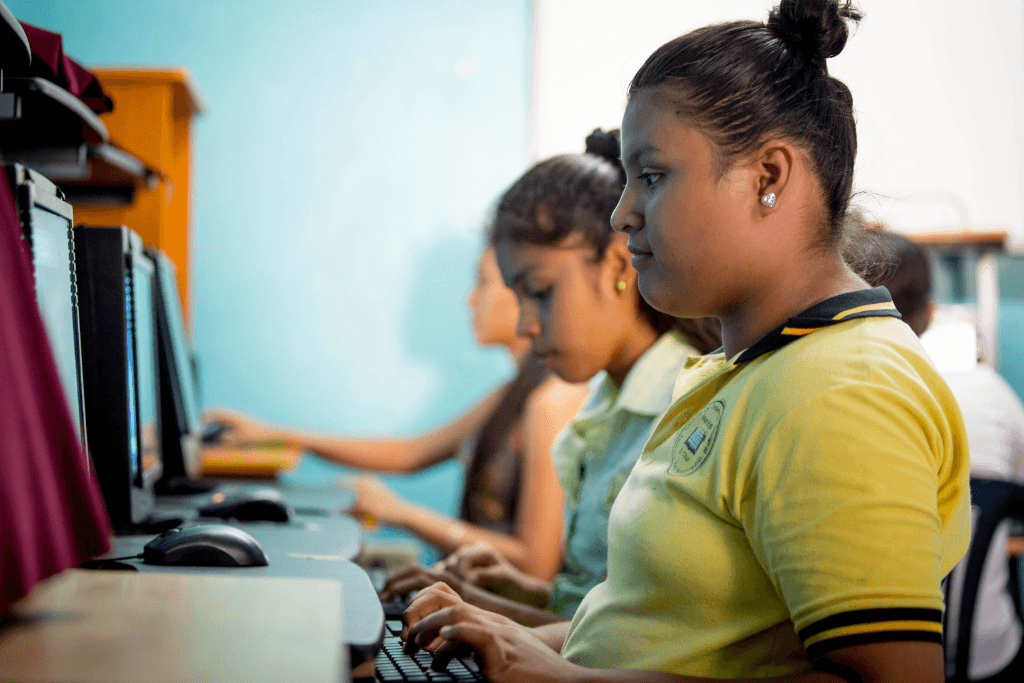 Children learning computer skills in El Salvador