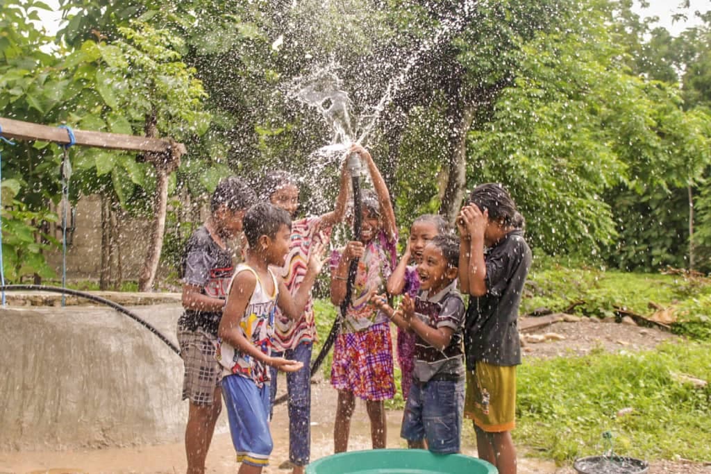 Yunita and friends play in clean water