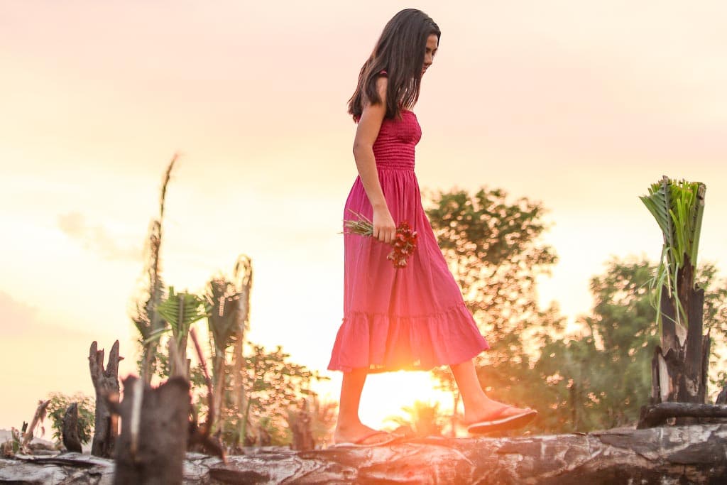 Her future bright, Yolane is walking free as the sun sets.