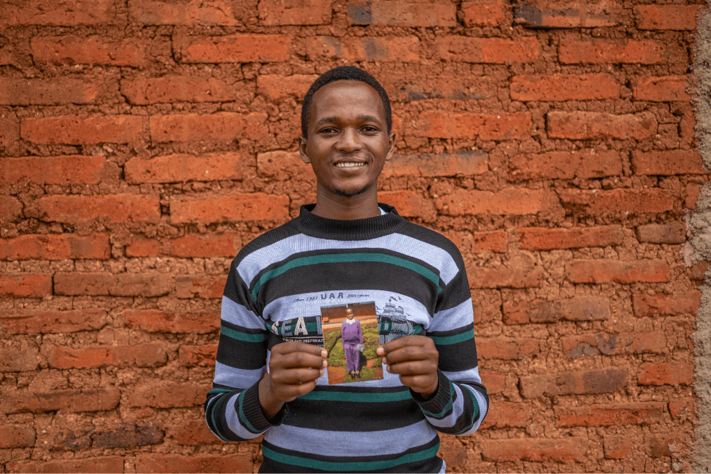 Emmanuel with a picture of him as a child