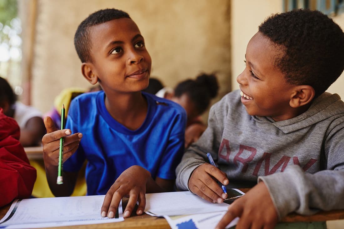 Boys in Ethiopia writing letters