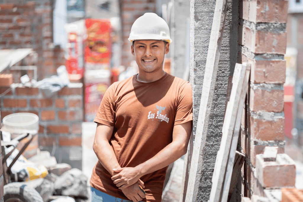 Jean Paul is an entrepreneur and provider in Peru. He is pictured in a construction hat and is smiling.
