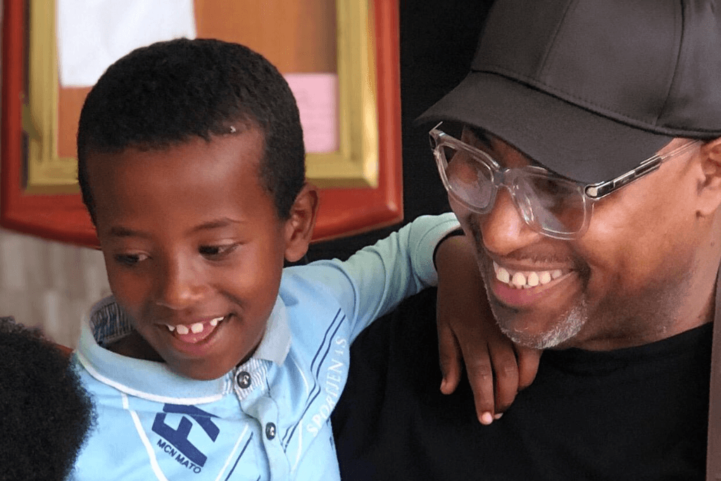 Bishop Wayne holding his sponsored child.
