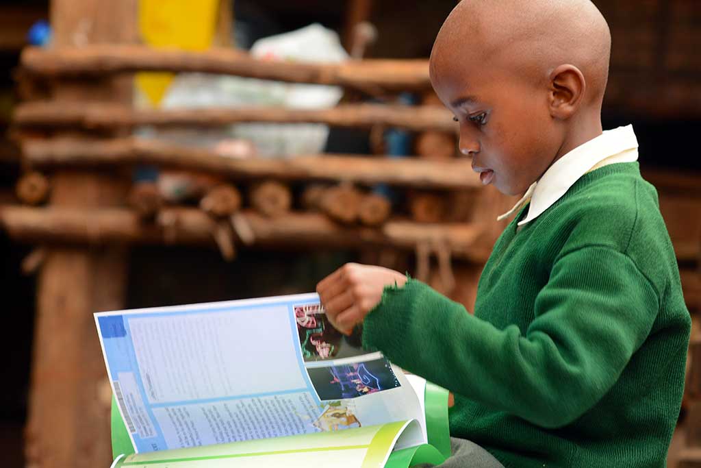 Watson from Kenya reading sponsor letters