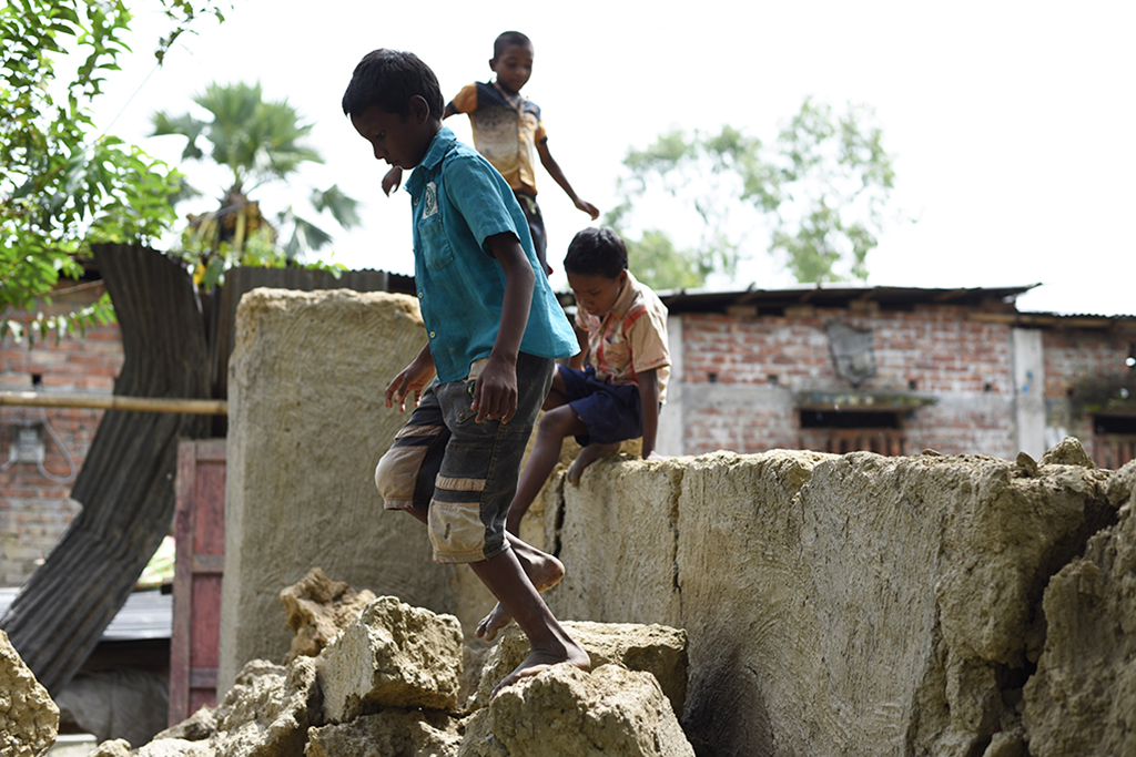 bangladesh flooding boys playing in rubble