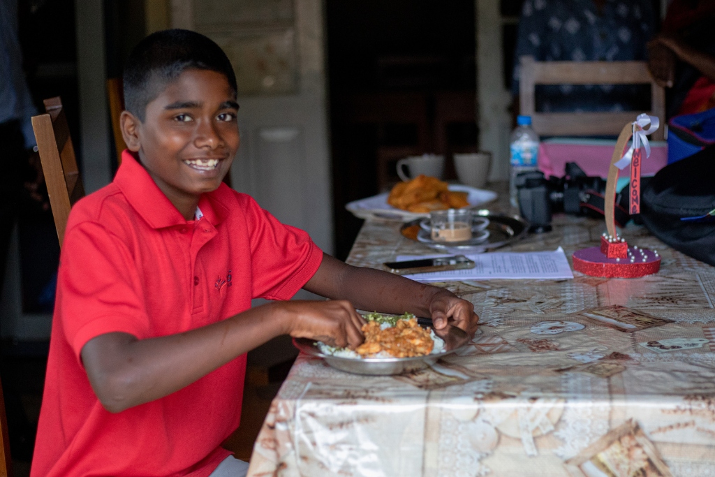 Compassion participant Askhan enjoying chicken feast Sri Lanka