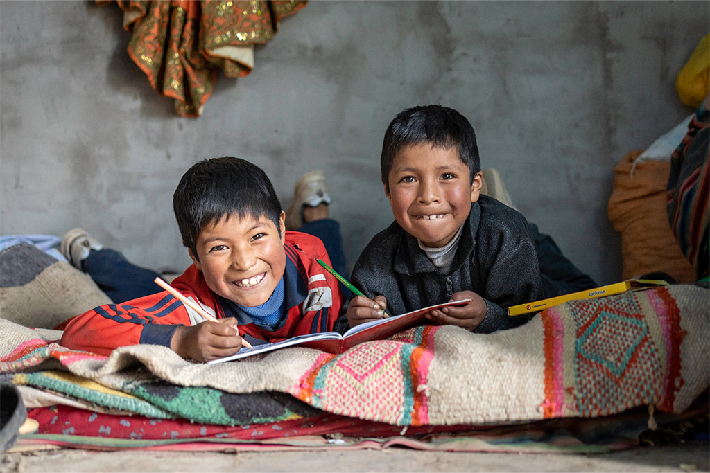 Two boys inside their home in Peru. 