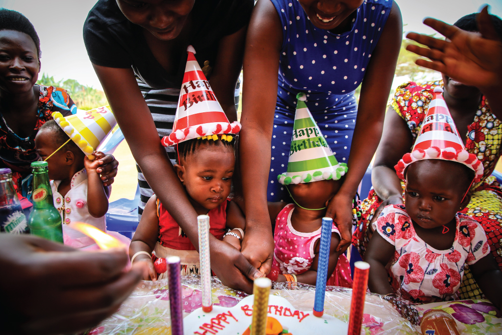 children with birthday cake and hats