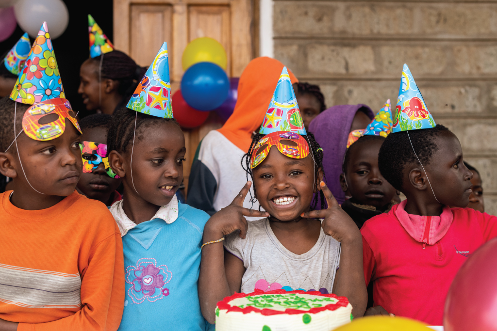 children with birthday party hats