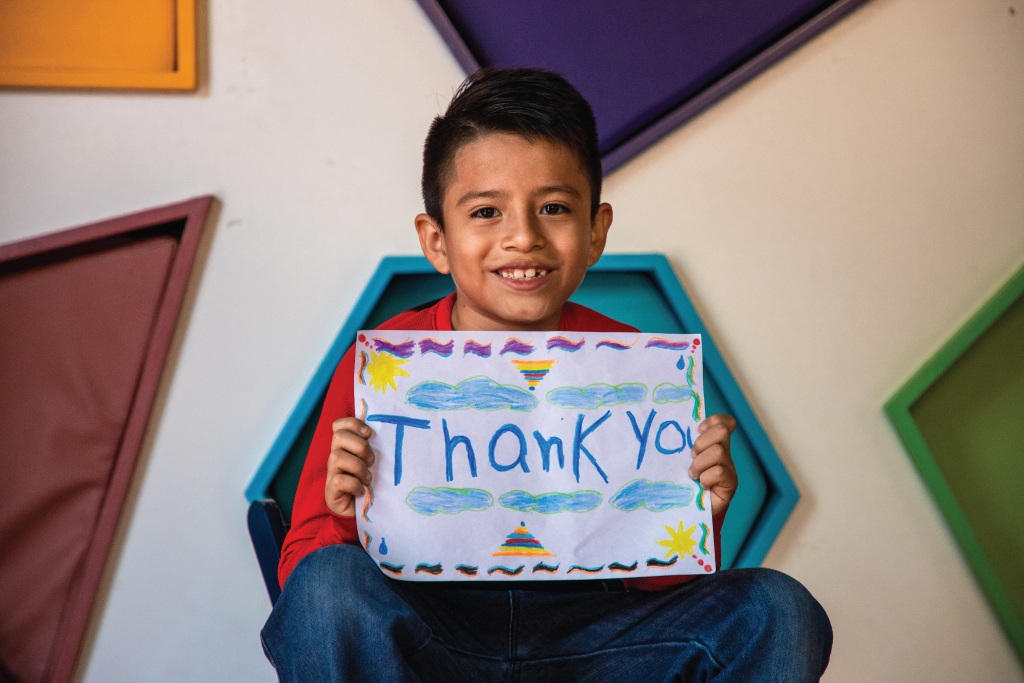 boy with thank you poster