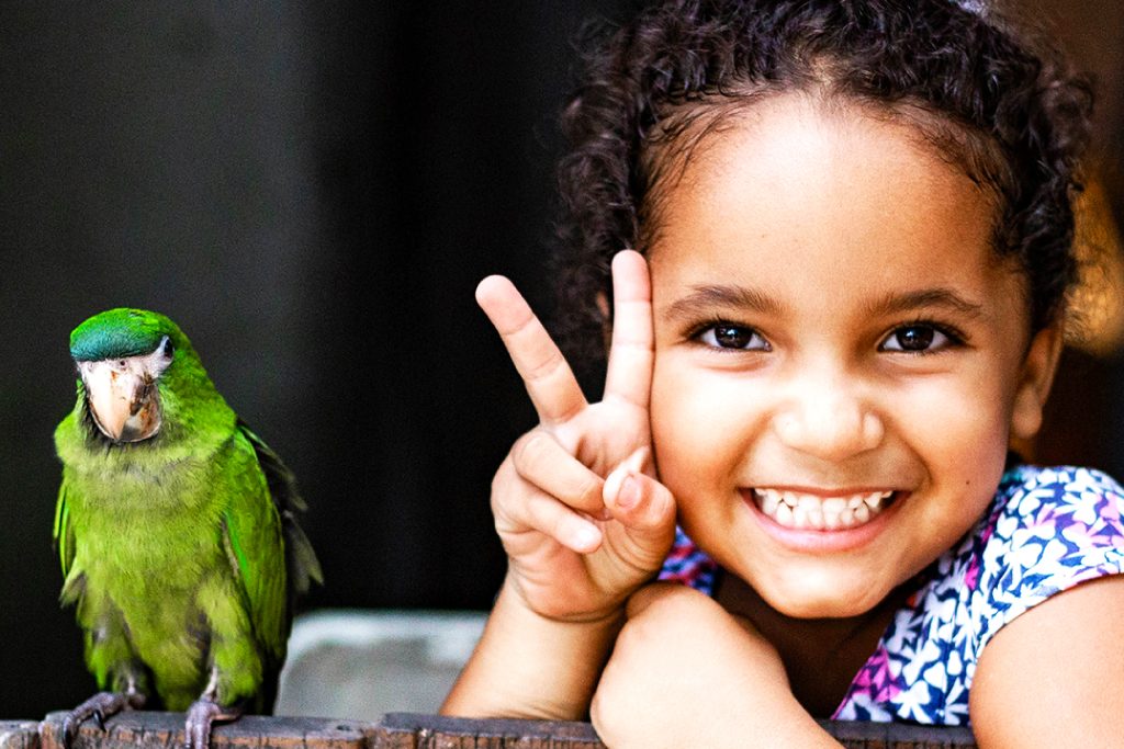 Maisa, aged 4, with Tico the parrot