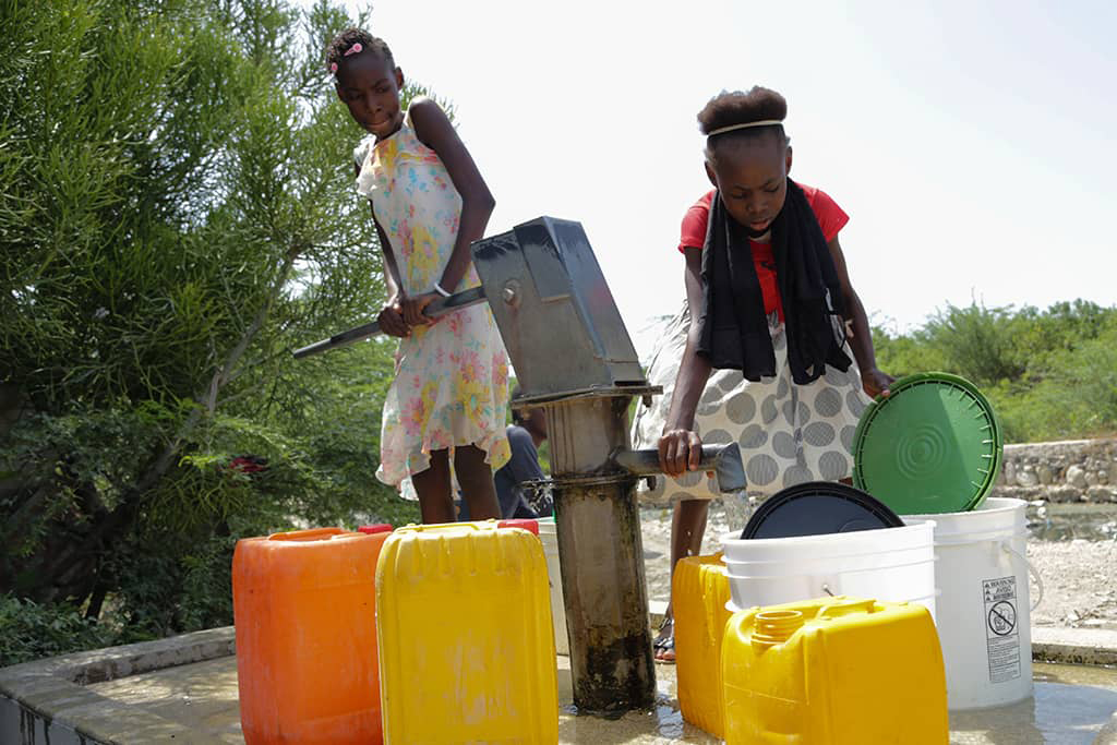 Shamaika collecting water in Haiti